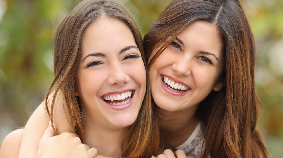 Two girls with beautiful straight smiles